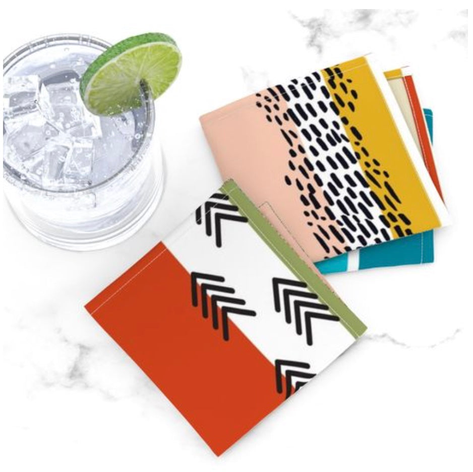 photo of a cocktail and cocktail napkins in a brightly colored stripe pattern with black accents