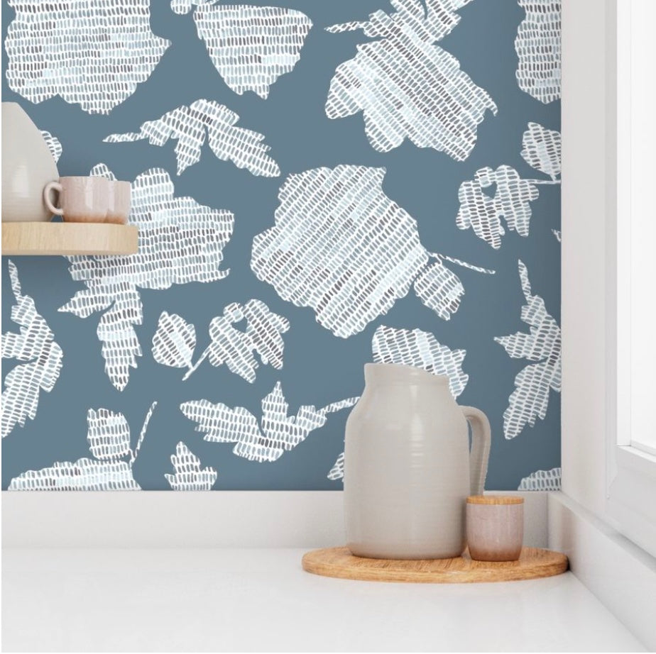 kitchen corner featuring dusty blue wall paper with a textured floral pattern and pottery