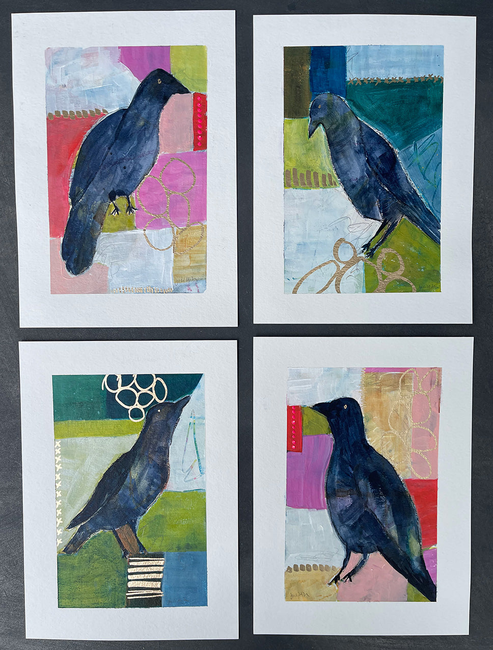 Flat lay of a series of four crow paintings in a grid