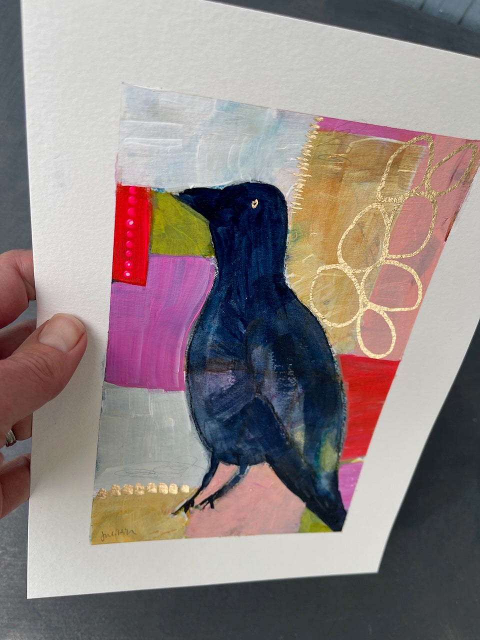 hand-held crow painting to show the glint from metallic marker