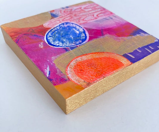 side view of vibrant mini collage art panel showing gold painted edges