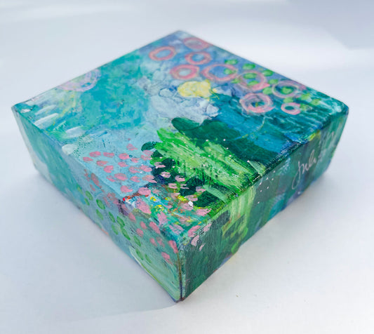 side view of mini abstract landscape painting in blues and greens showing painted wrap around edges