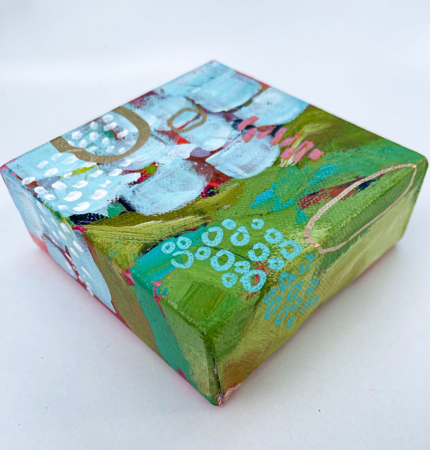 side view of mini abstract landscape painting green and blue with gold accents showing wrap around painted edges