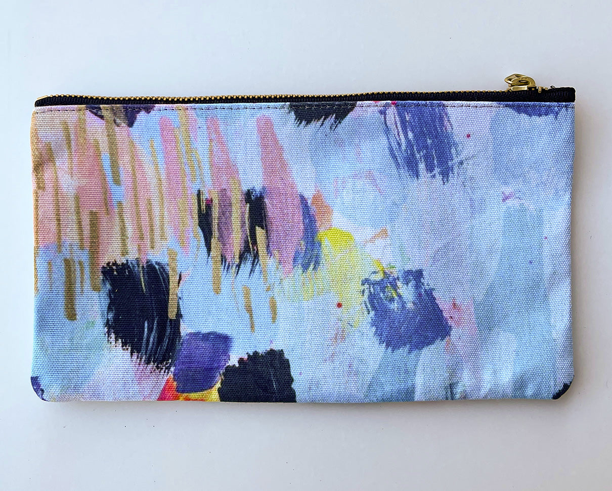 top view of pale blue zipper pouch with abstract brush strokes