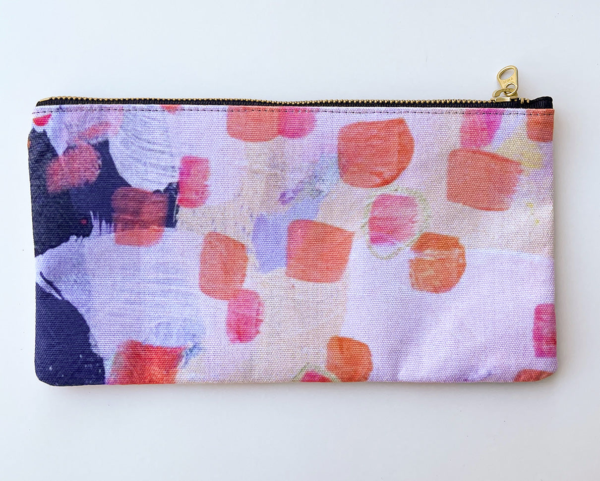 front view of pale pink zipper pouch with orange and navy accents